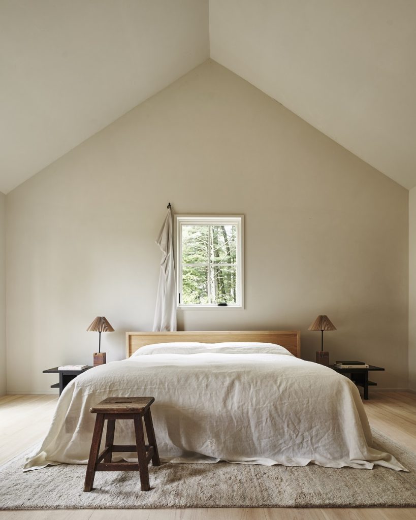 low, king-sized bed in a room with angled ceiling