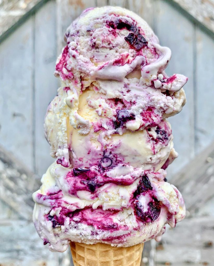 triple-dip ice cream cone of raspberry ice cream