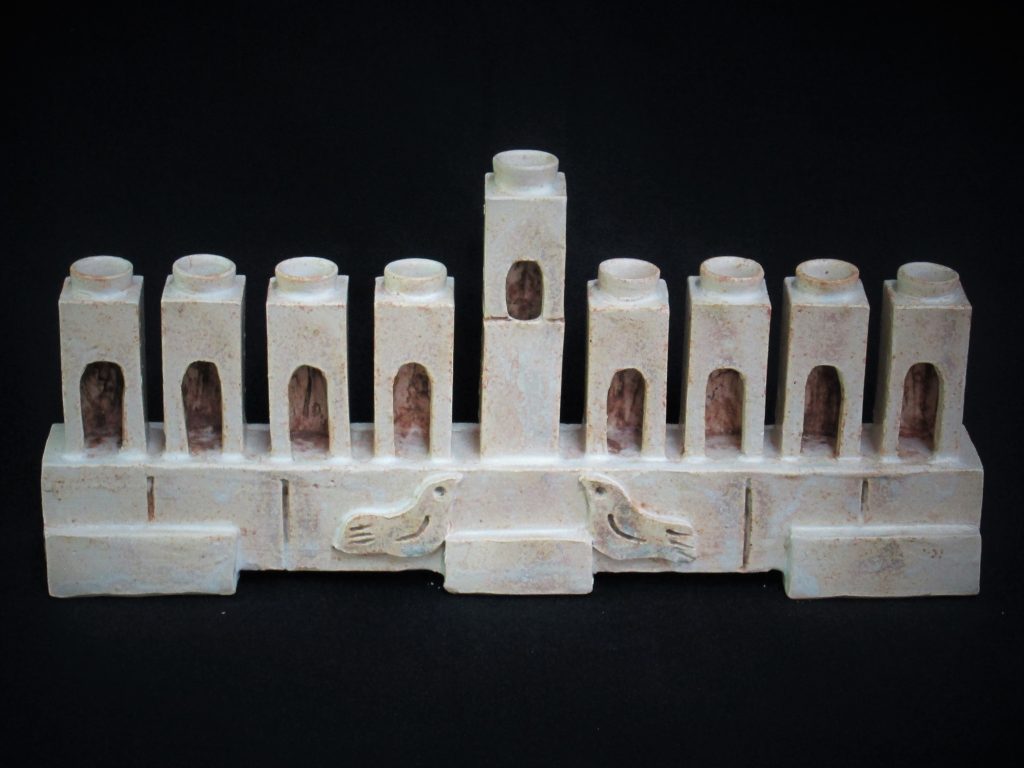clay pottery featuring towers and birds