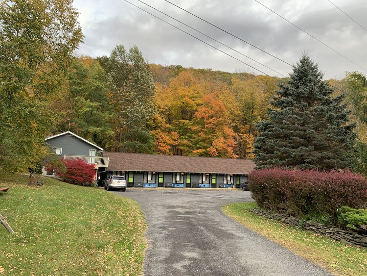 Starlite Motel Entrance with autumn colors on the hill in the background