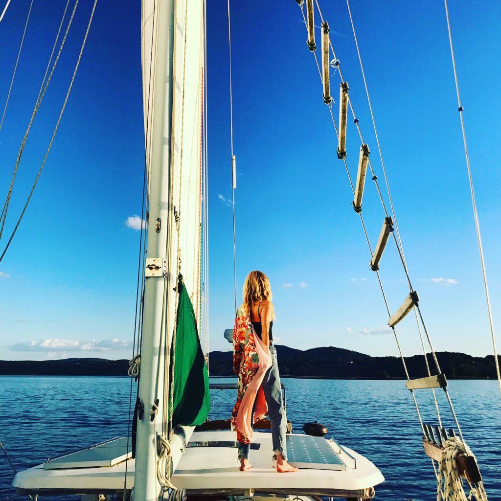 Woman standing on a sailboat