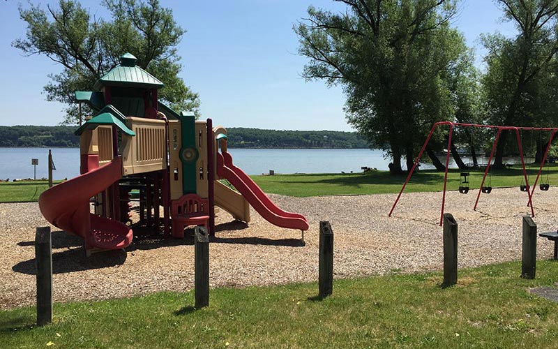 children's playground equipment next to a lake