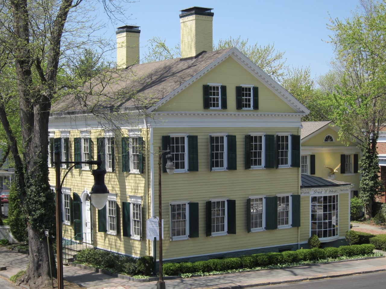 large, yellow, two-story clapboard house