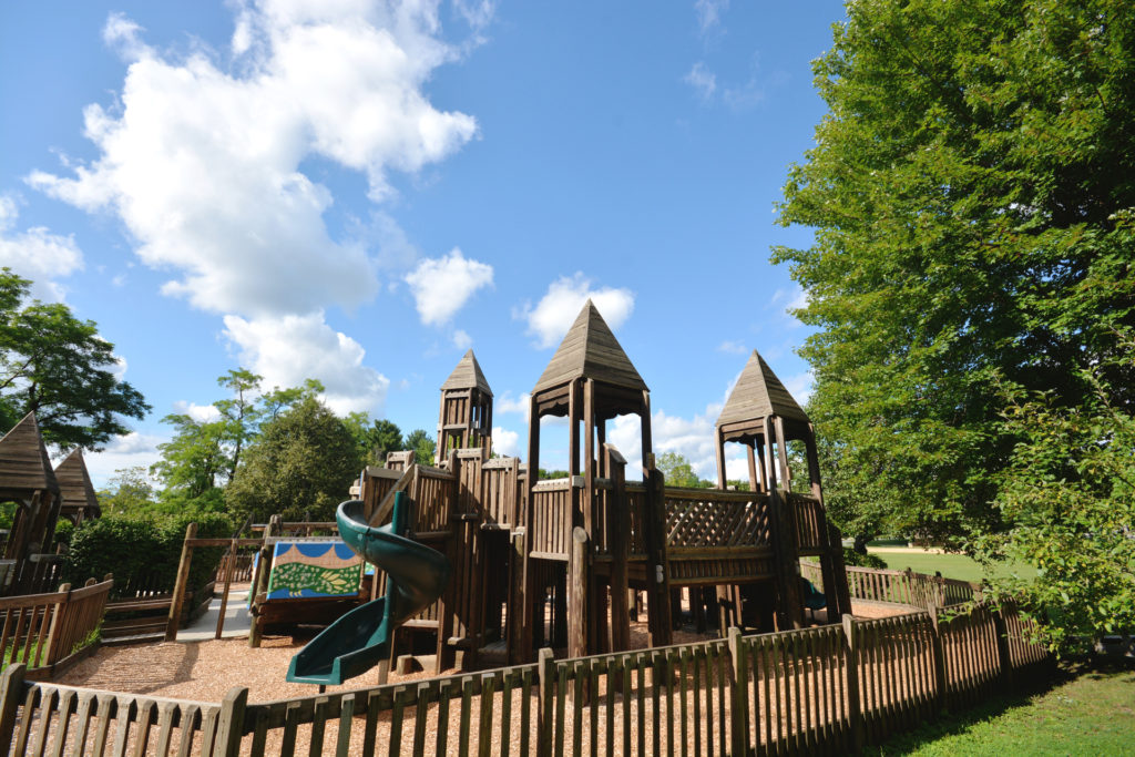 children's wooden playground equipment with green slide