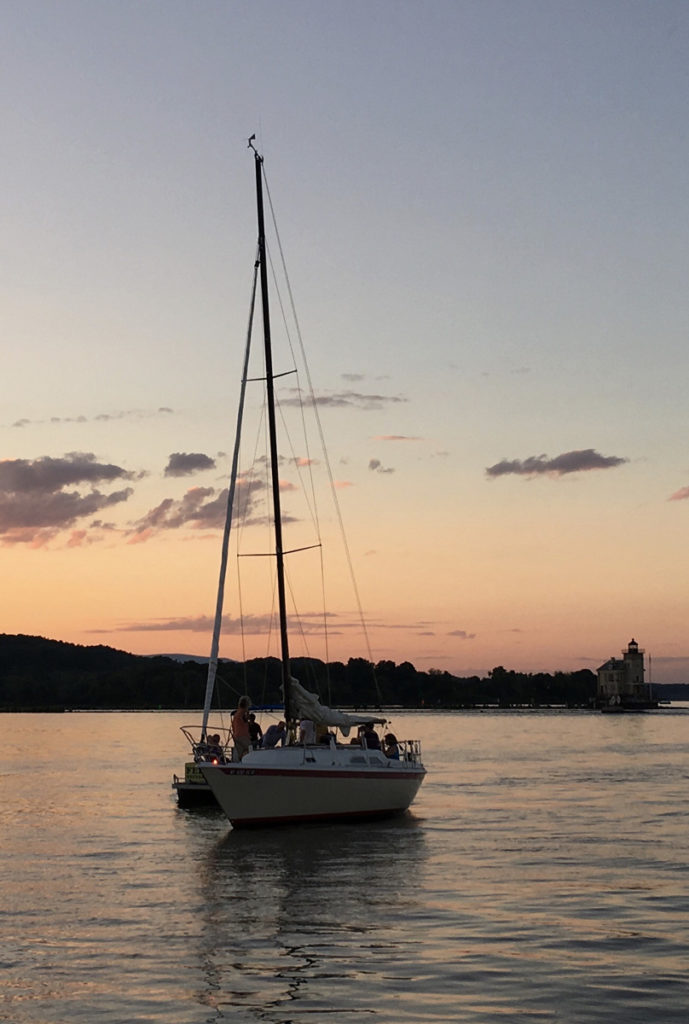 sailboat on river at sunset