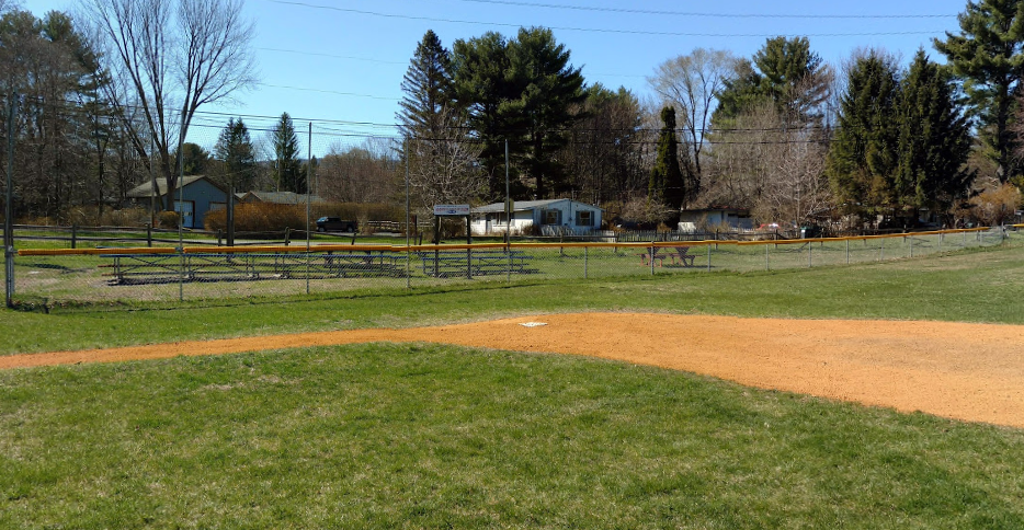 baseball diamond with buildings in the background