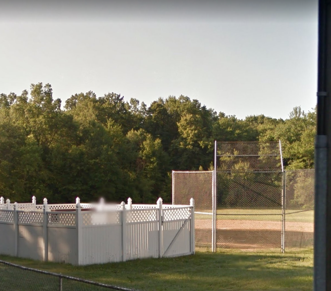 baseball diamond with a white fence nearby