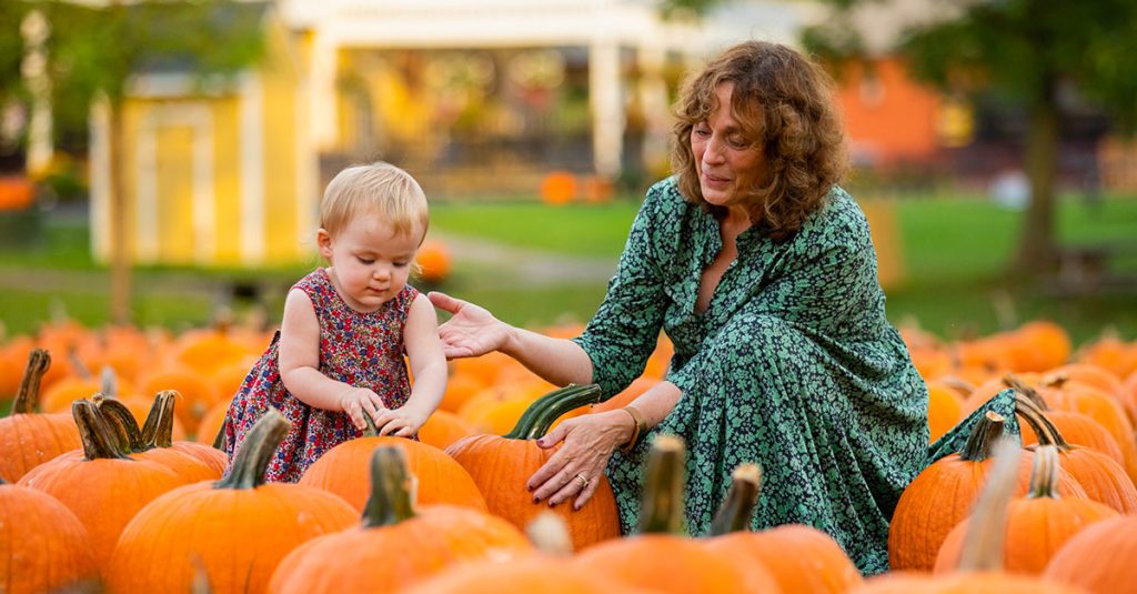 little girl and grandma in pumpkin patch 