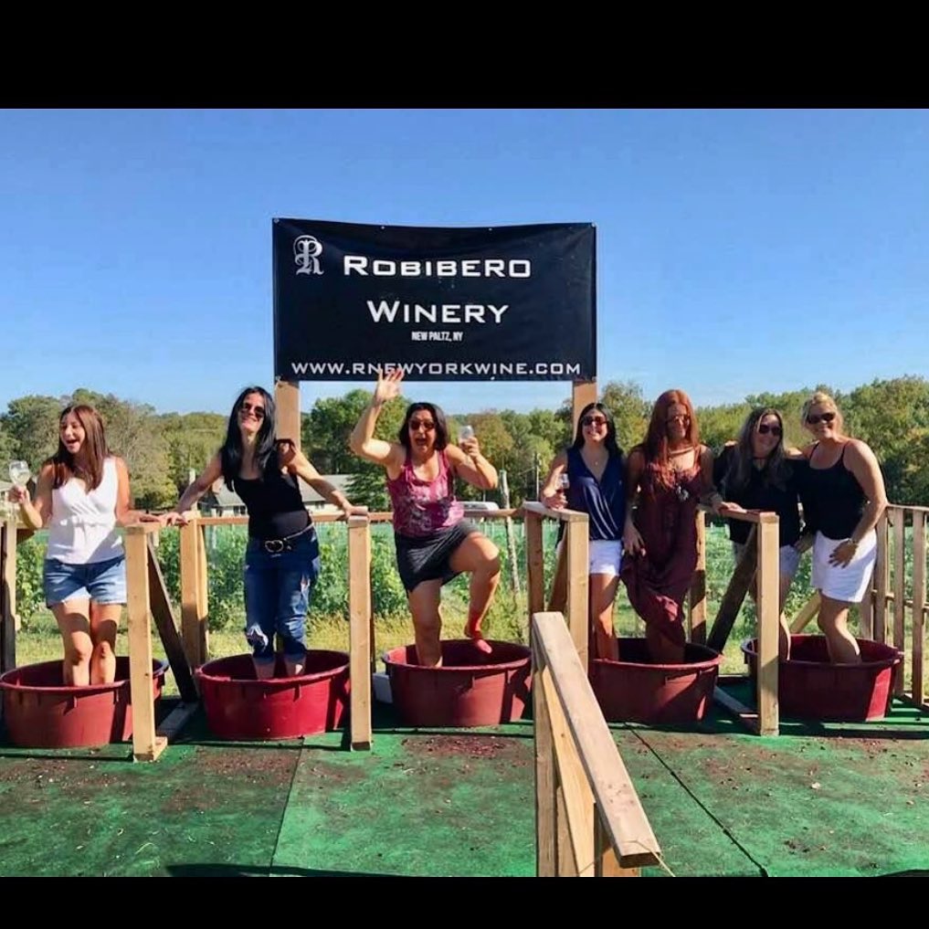 group of seven ladies stomping grades in five red buckets