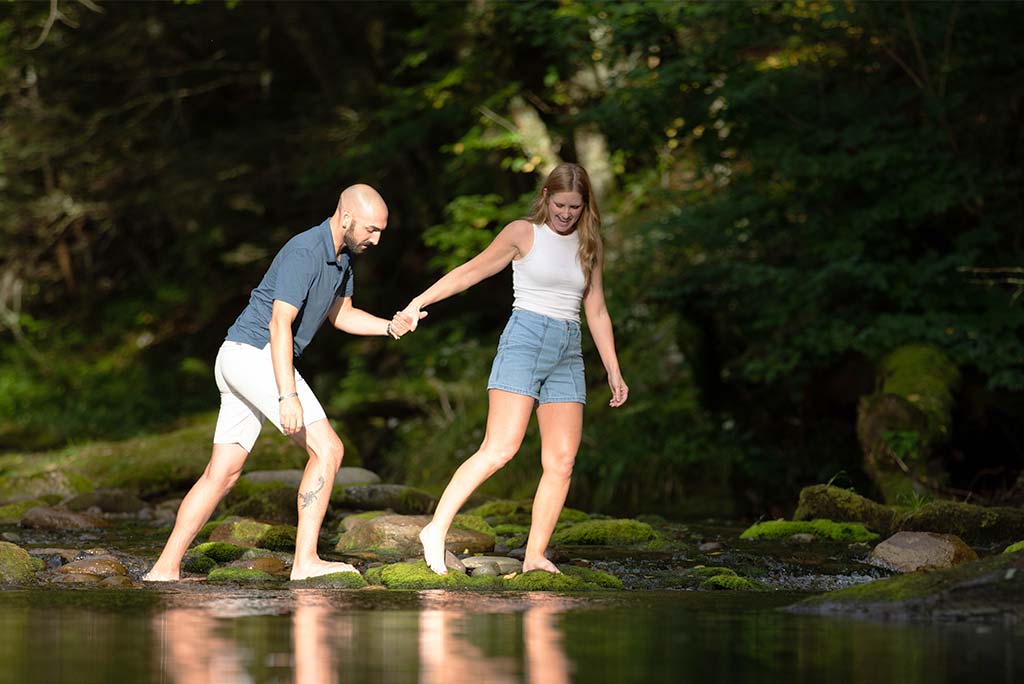 Man and woman walking along a river