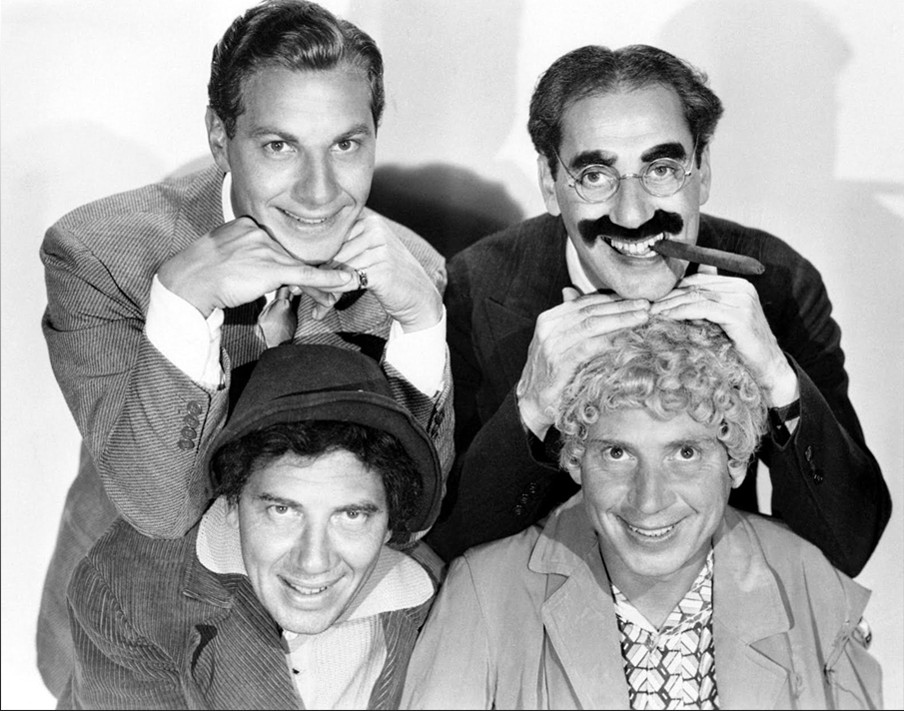 the four Marx brothers posing for a comedy promotion