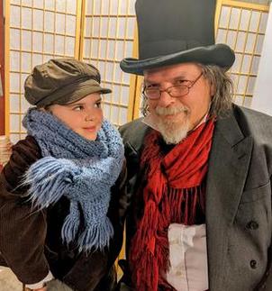 Scrooge and Tiny Tim in old-fashioned clothes