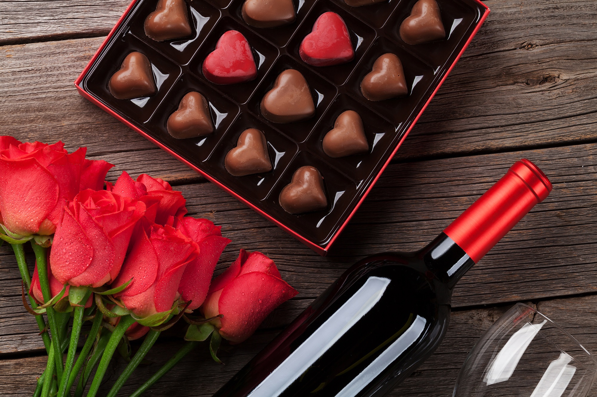 box of chocolate hearts and bottle of red wine