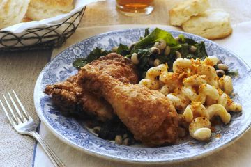blue china plate with fried chicken and mac and cheese