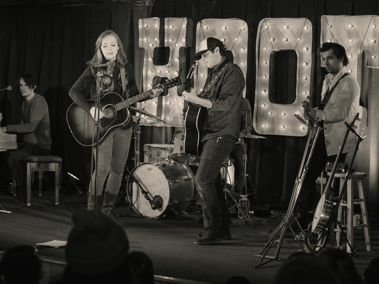 black and white photo of band on stage