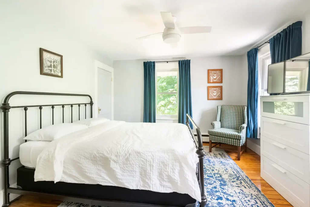 bed and breakfast room with iron bed frame and white bedding