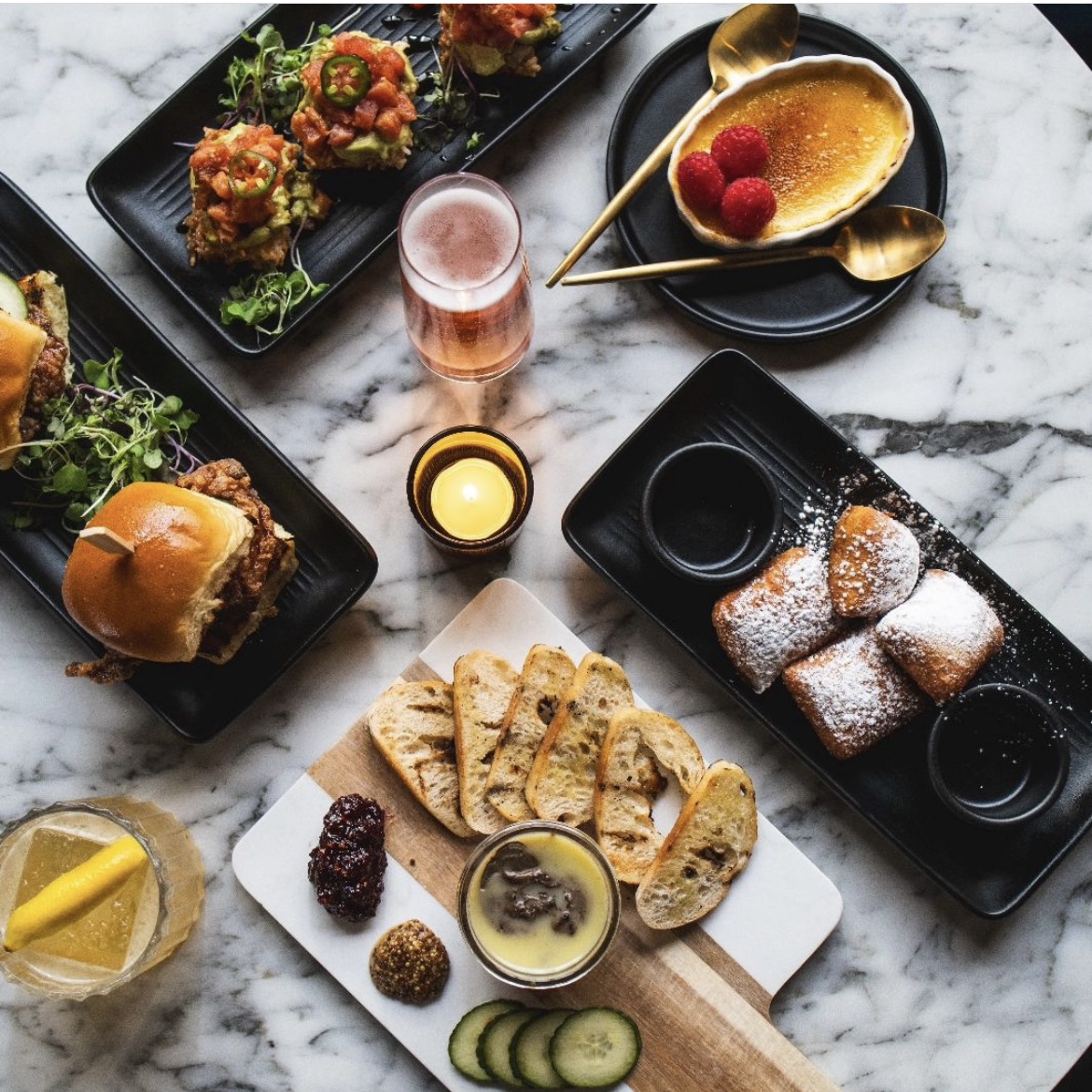 small trays of appetizers that include sliders and beignets