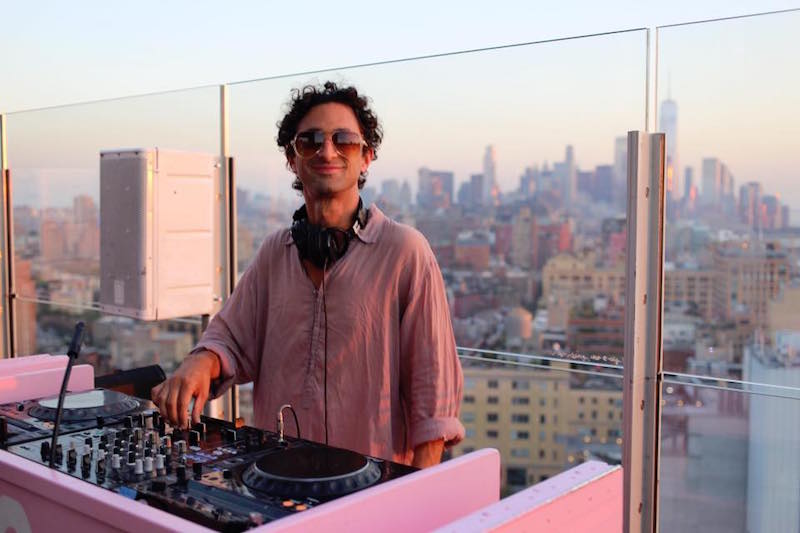 disc jockey playing music on the top floor of a high-rise building