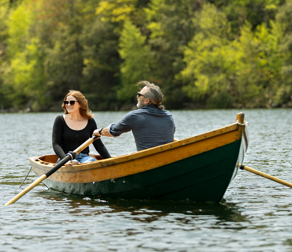 Man and women rowing a boat.