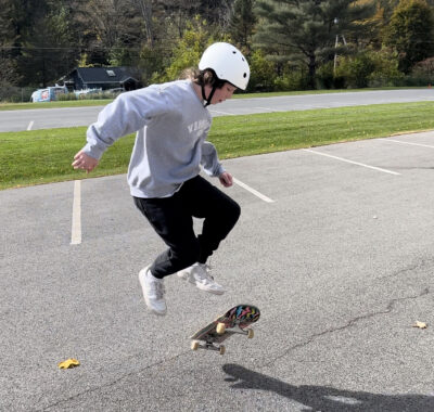 skater jumping above skateboard