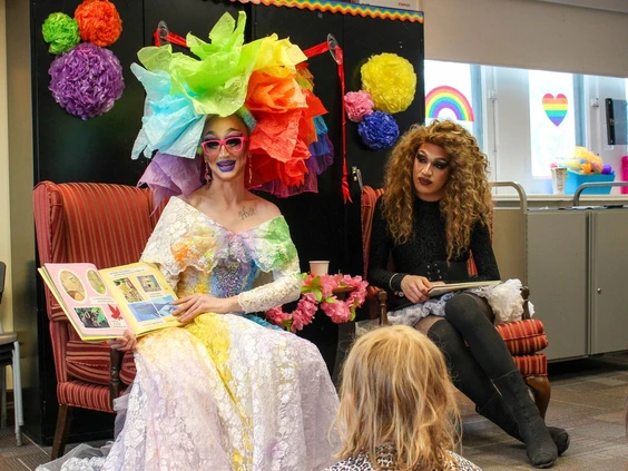 Drag queens reading book to kids