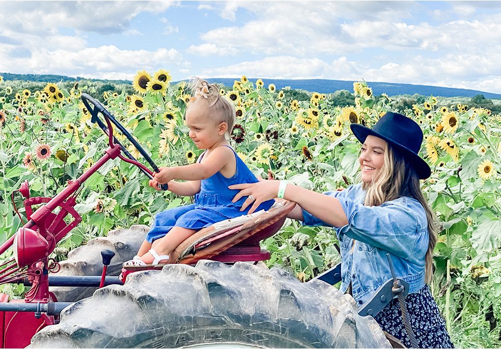 Mom and daughter in sunflower field