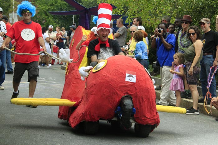 man dressed as cat in the hat with a cat in the hat themed soapbox derby cart