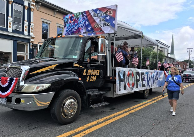 LARGE TRUCK CARRYING THE PEOPLE OF HOPE ROCKS IN THE 4TH OF JULY PARADE