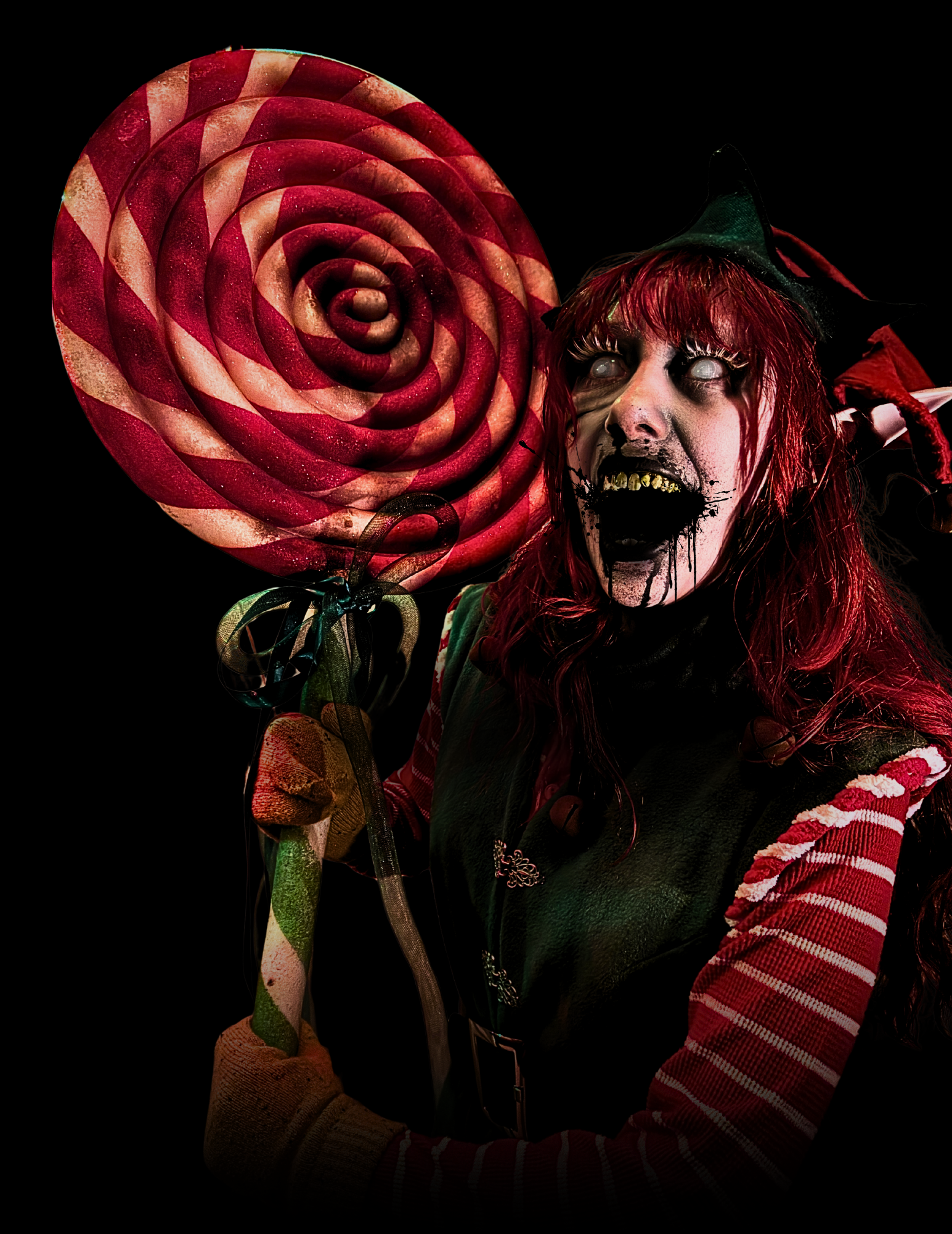 Person in festive costume holding an oversized red and white swirled lollipop in a dark setting.