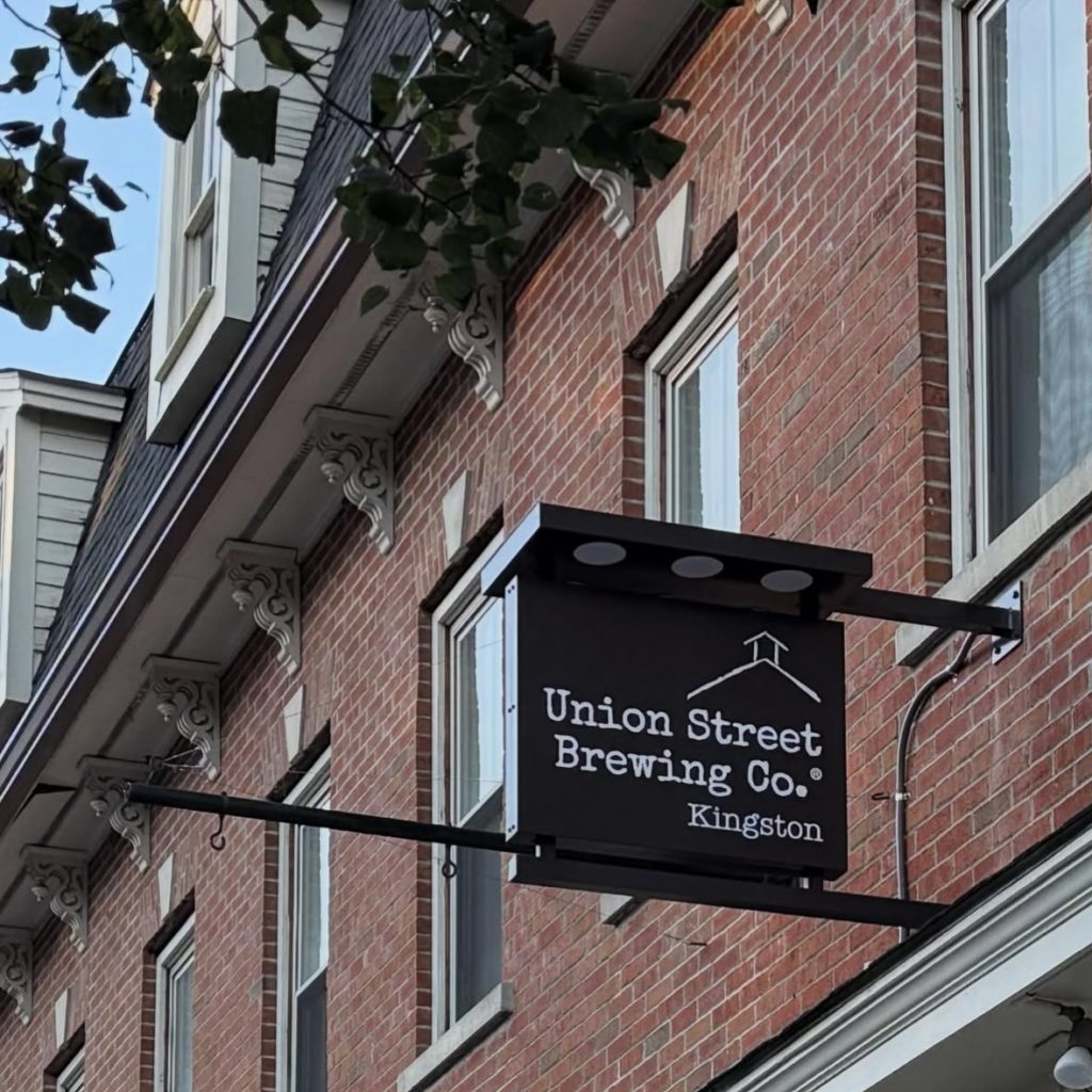 Union Street Brewing Co. Kingston sign mounted on a brick building exterior.